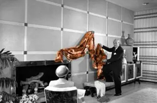 Now that’s a presentation! Combing thru some files while working on my certification course, I came across this photo of William “Billy” Haines making a drapery presentation to a client.  William “Billy” Haines was an American actor and interior designer. Known for his impeccable taste in interior design and love for vintage pieces, Haines worked closely many celebrities. His career was launched by his unconventional choice of an all-white decor for his friend, Joan Crawford’s living room. 
Haines’ signature style incorporated custom-made modern furnishings and period antiques with touches of Chinoiserie and exotic artifacts in a glamorous mix that would retrospectively become known as Hollywood Regency style. The centerpieces of Haines’ interiors were his custom designs including tufted sofas, iconic chairs –the Seniah, the Elbow, the Pull Up and the Hostess.  Haines hired talented local artists, craftsmen and workshops to produce his one of a kind custom pieces specially crafted per client.  #loveagoodpresentation #windowdressings #designicon #americanasethetic #hollywoodregency l